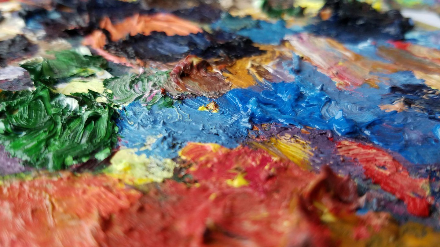 Thick colorful blobs of oil paint on a surface.